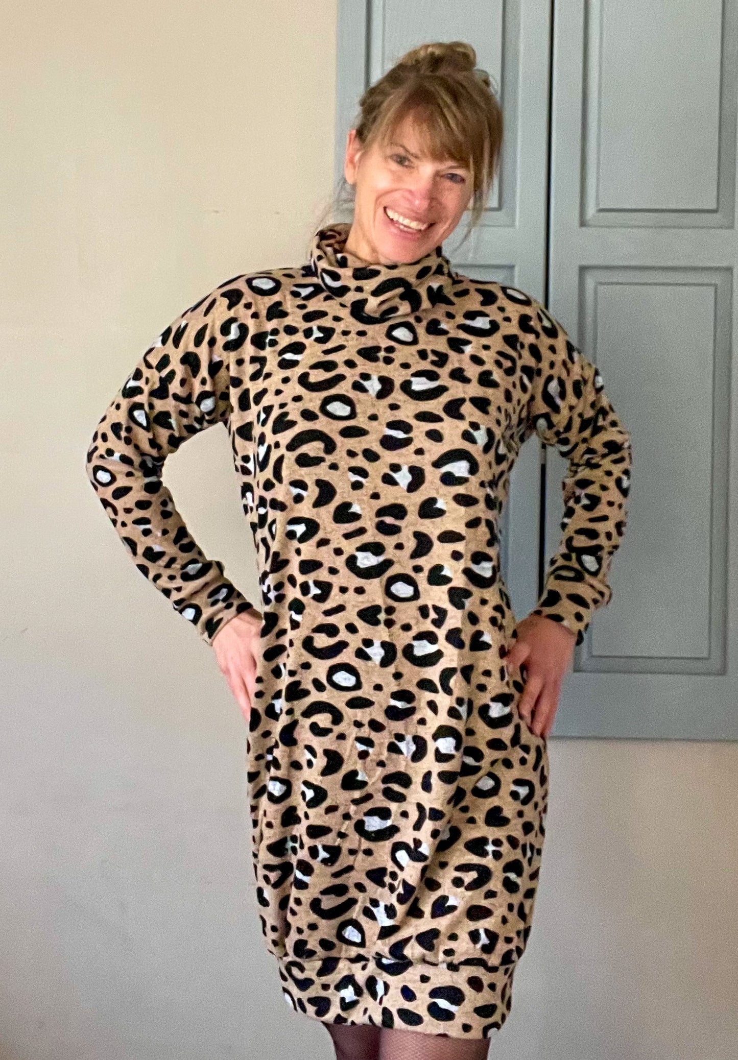 image of person wearing leopard turtleneck sweater dress