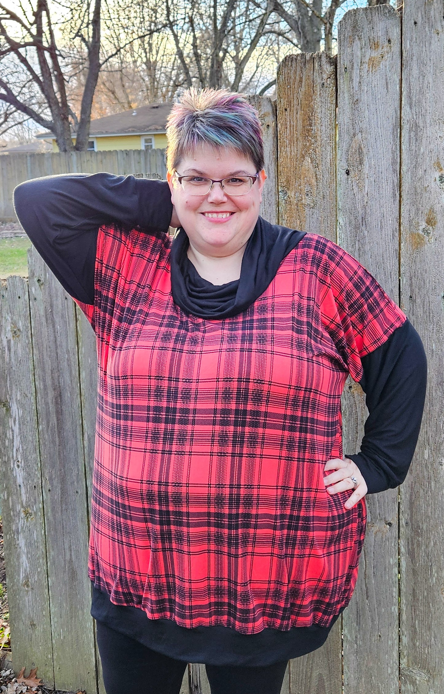 image of person wearing red and black plaid tunic