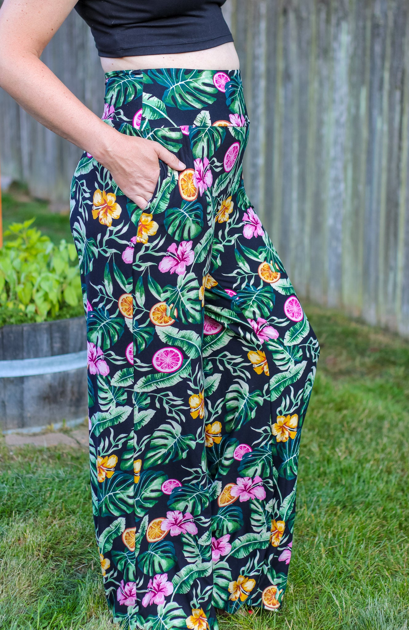 Image of green floral Rivet Patterns Pothos Pants being worn