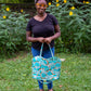 Image of blue rainbow Rivet Patterns Wave Top Tote being held