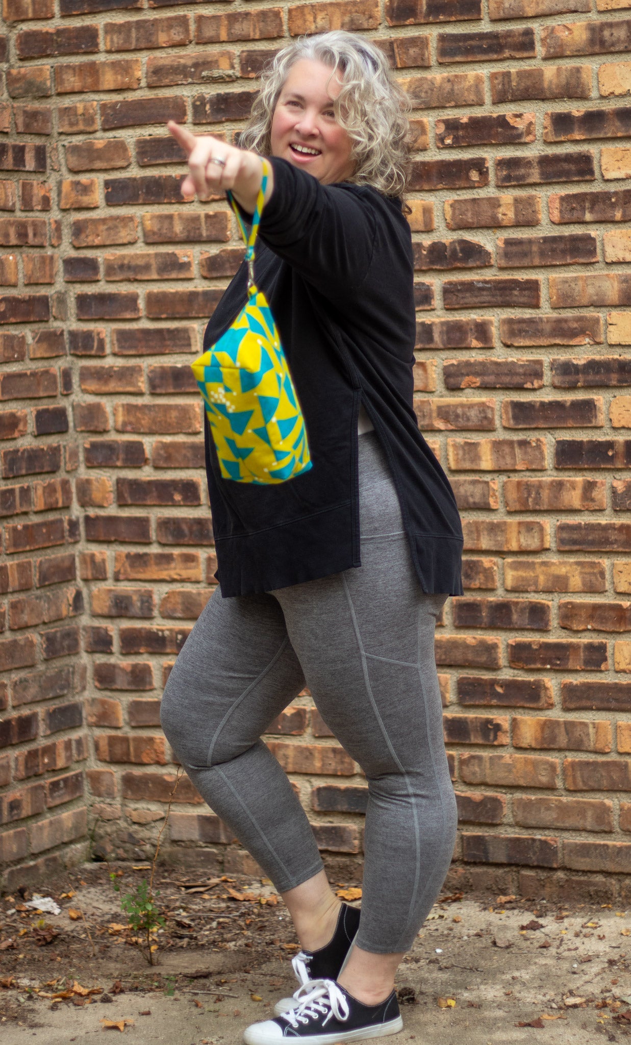 Image of yellow and blue Rivet Patterns Prelude Pouch being held