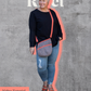 Image of gray and orange Rivet Allegro Crossbody Bag being worn
