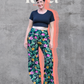 Image of green floral Rivet Patterns Pothos Pants being worn