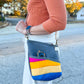 Image of pink, yellow, and blue Rivet Allegro Crossbody Bag being worn.