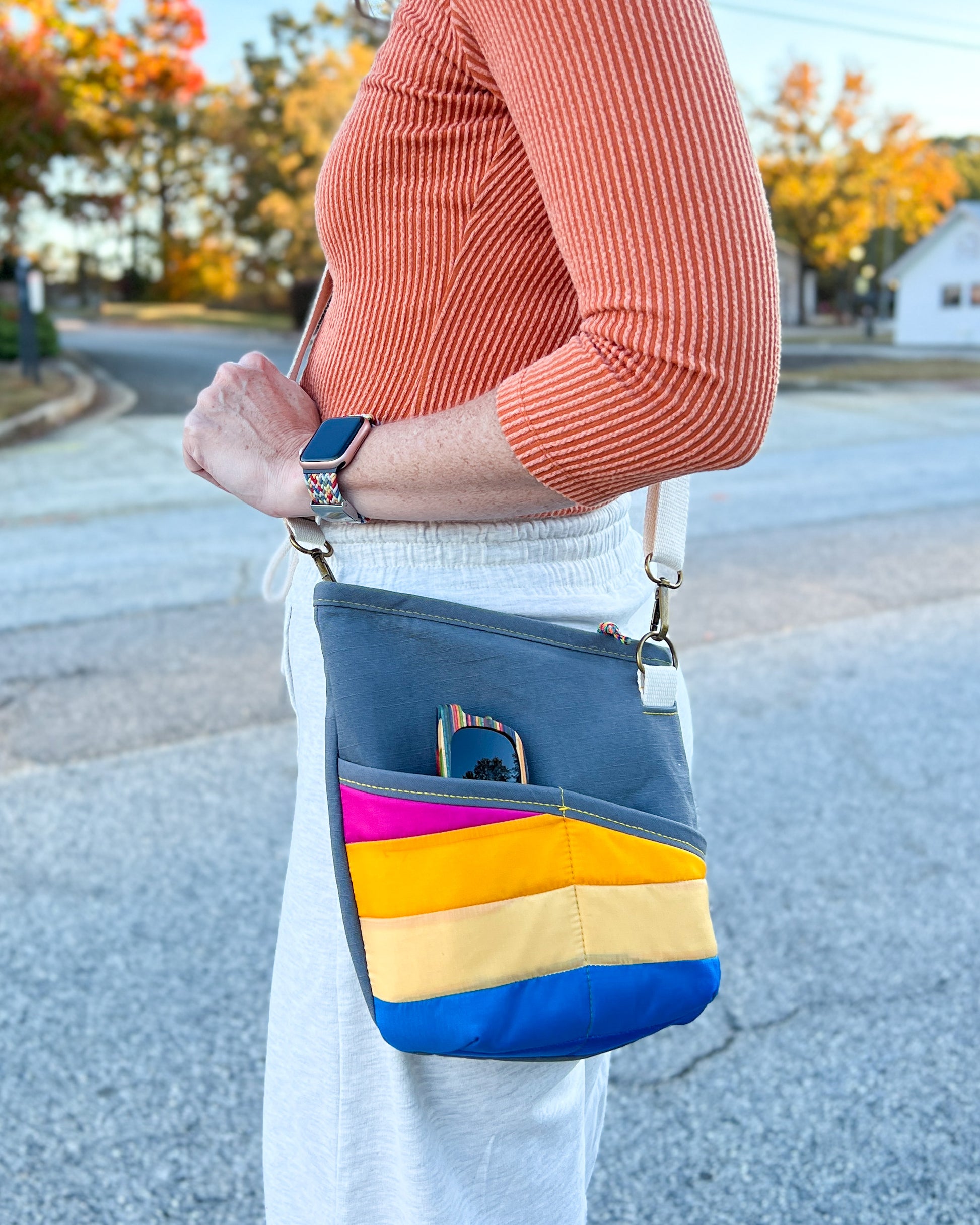 Image of pink, yellow, and blue Rivet Allegro Crossbody Bag being worn.