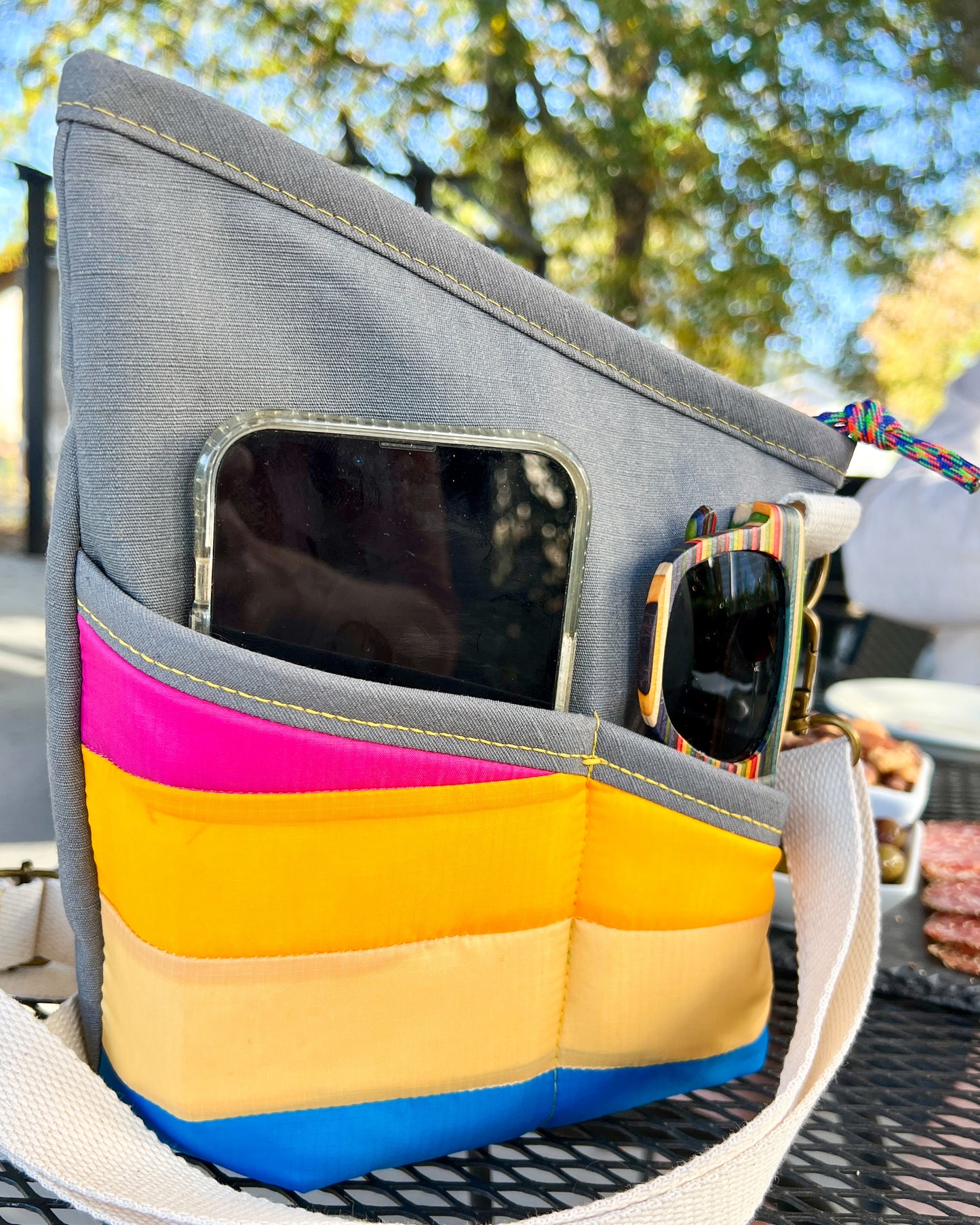 Image of pocket close up of pink, yellow and blueRivet Allegro Crossbody Bag
