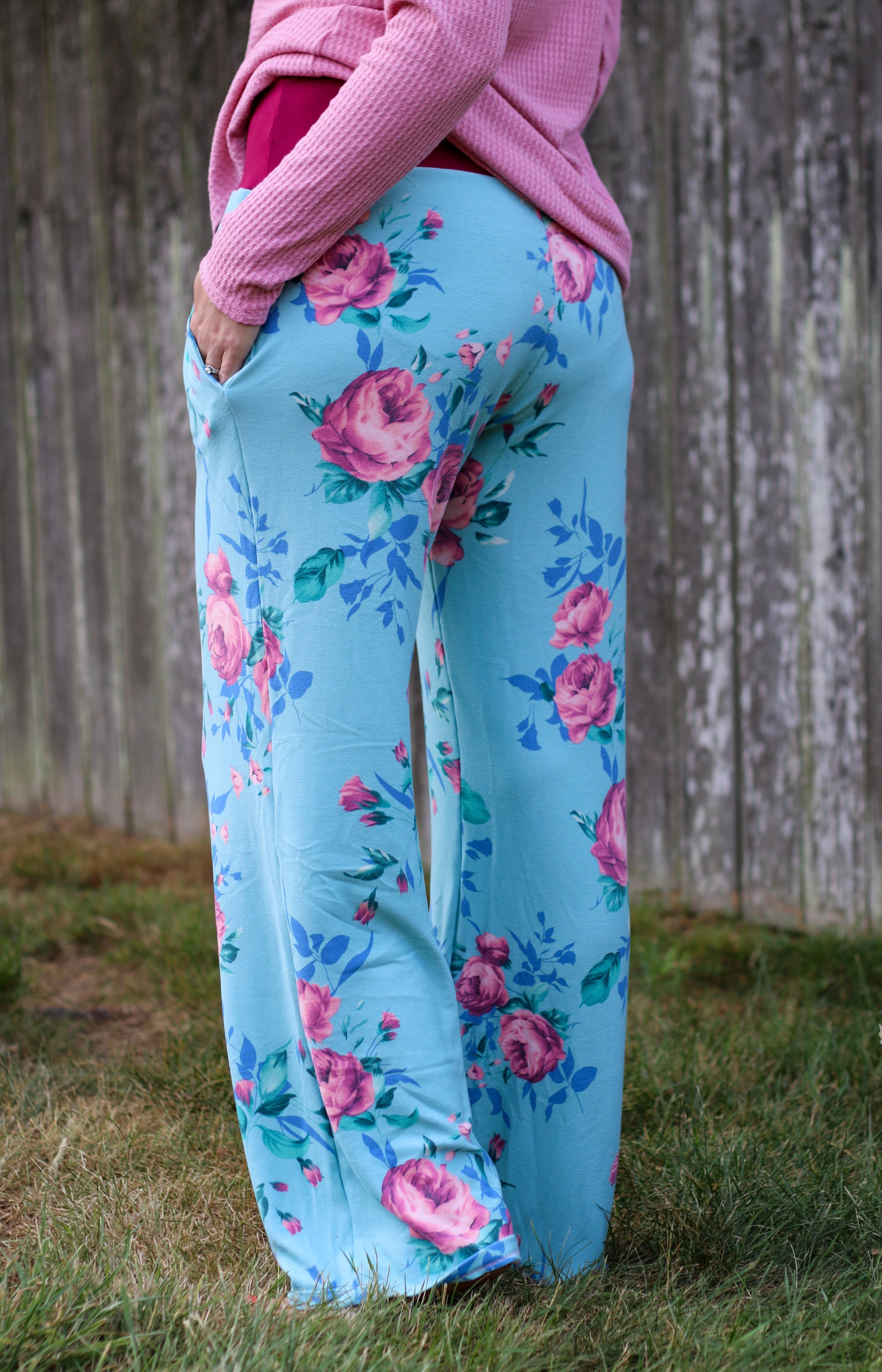 Image of blue floral Rivet Patterns Pothos Pants being worn pockets