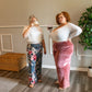 Image of two people wearing Rivet Patterns Pothos Lounge Pants blue floral and pink velvet