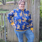 Image of blue floral Rivet Patterns Alpine Sweatshirt with hood, cuffs, and hem band.